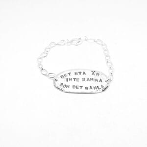 ovalt silverarmband med text med vit bakgrund