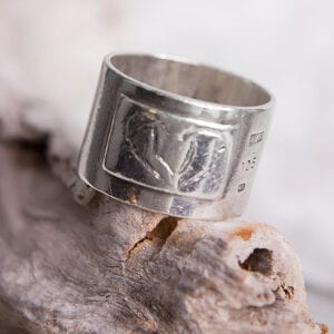 bred silverring på trädgren