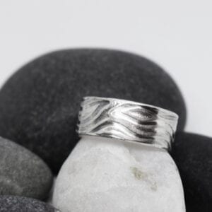 mönstrad silverring mot stenar
